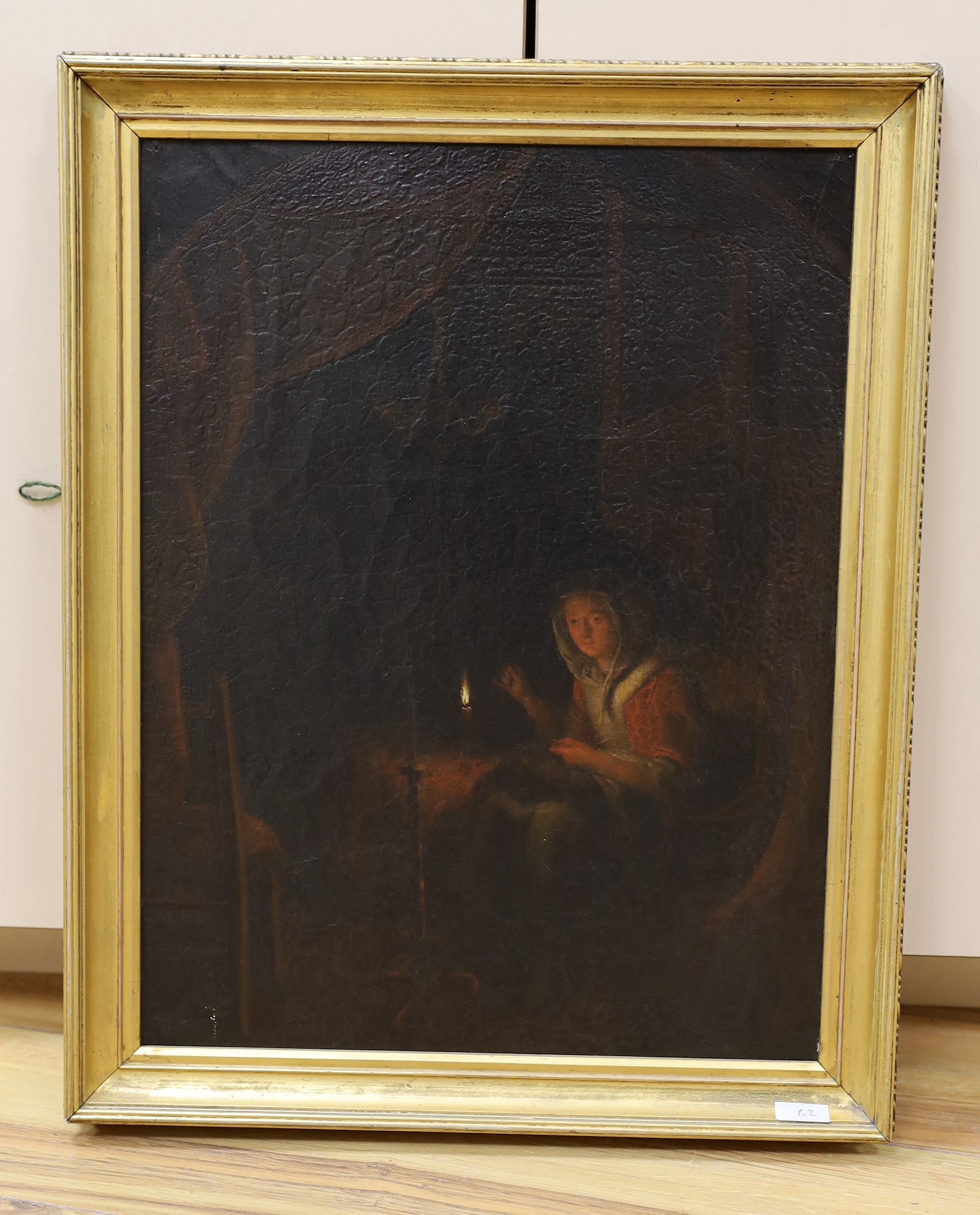 Manner of Godfried Schalcken (Dutch, 1643-1706), oil on canvas, Figure working beside candlelight, label to reverse, 43 x 32cm